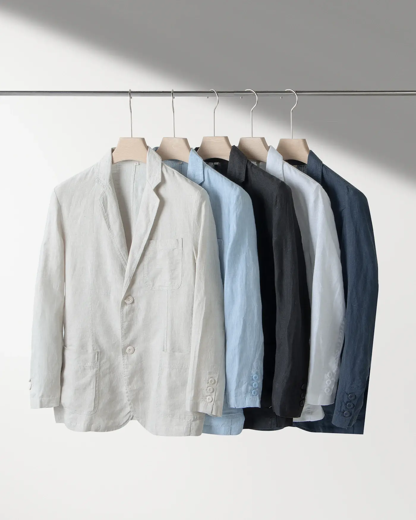 Jackets in white, pale blue and navy hanging on a rail