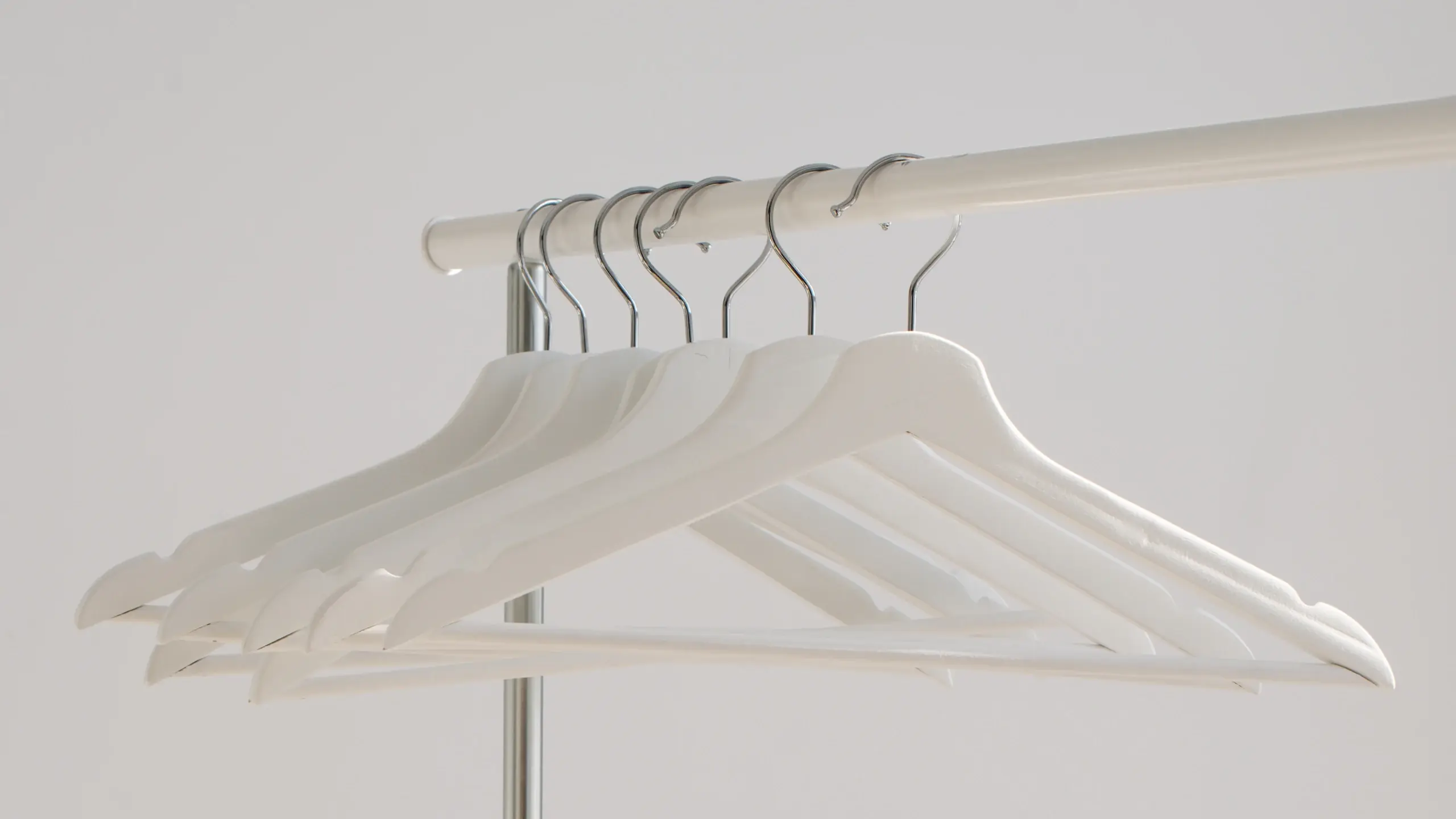 Empty white hangers on a rail